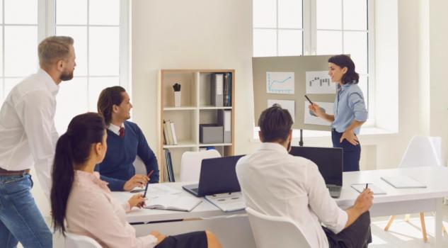 Team presentation discussing start up business ideas with charts displayed.