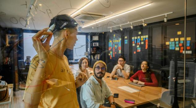 Team brainstorming start up business ideas during creative office meeting.