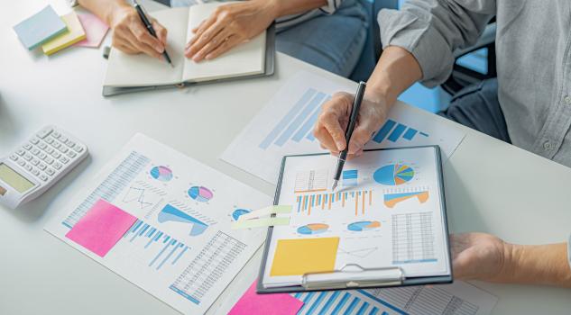 The Entrepreneurial Mindset analyzing charts and start up business ideas.